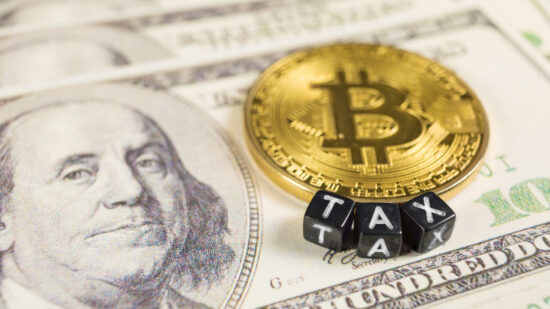 Bitcoin tax concept on dollar bills